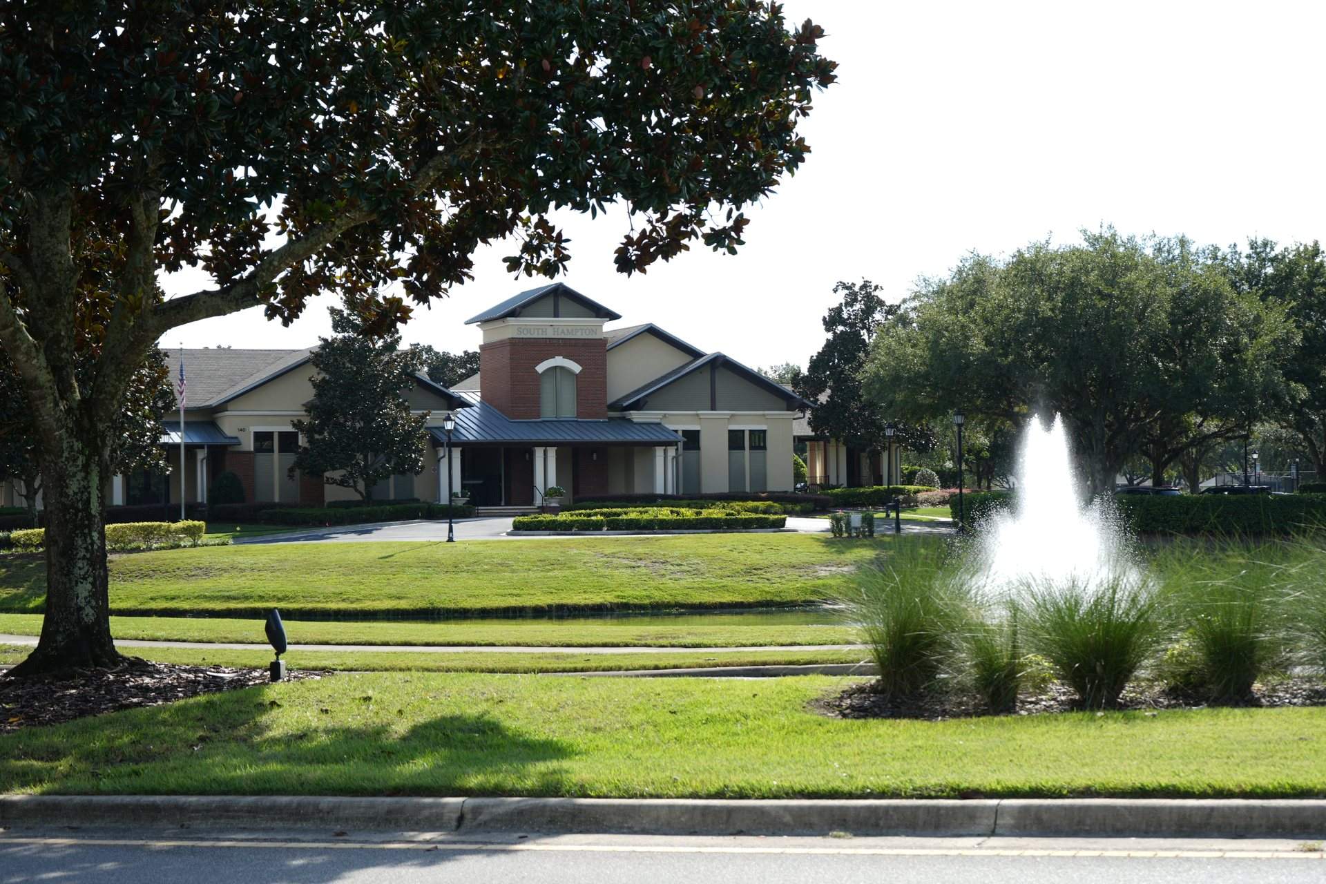 South Hampton clubhouse lawn with a fountain beside a large oak