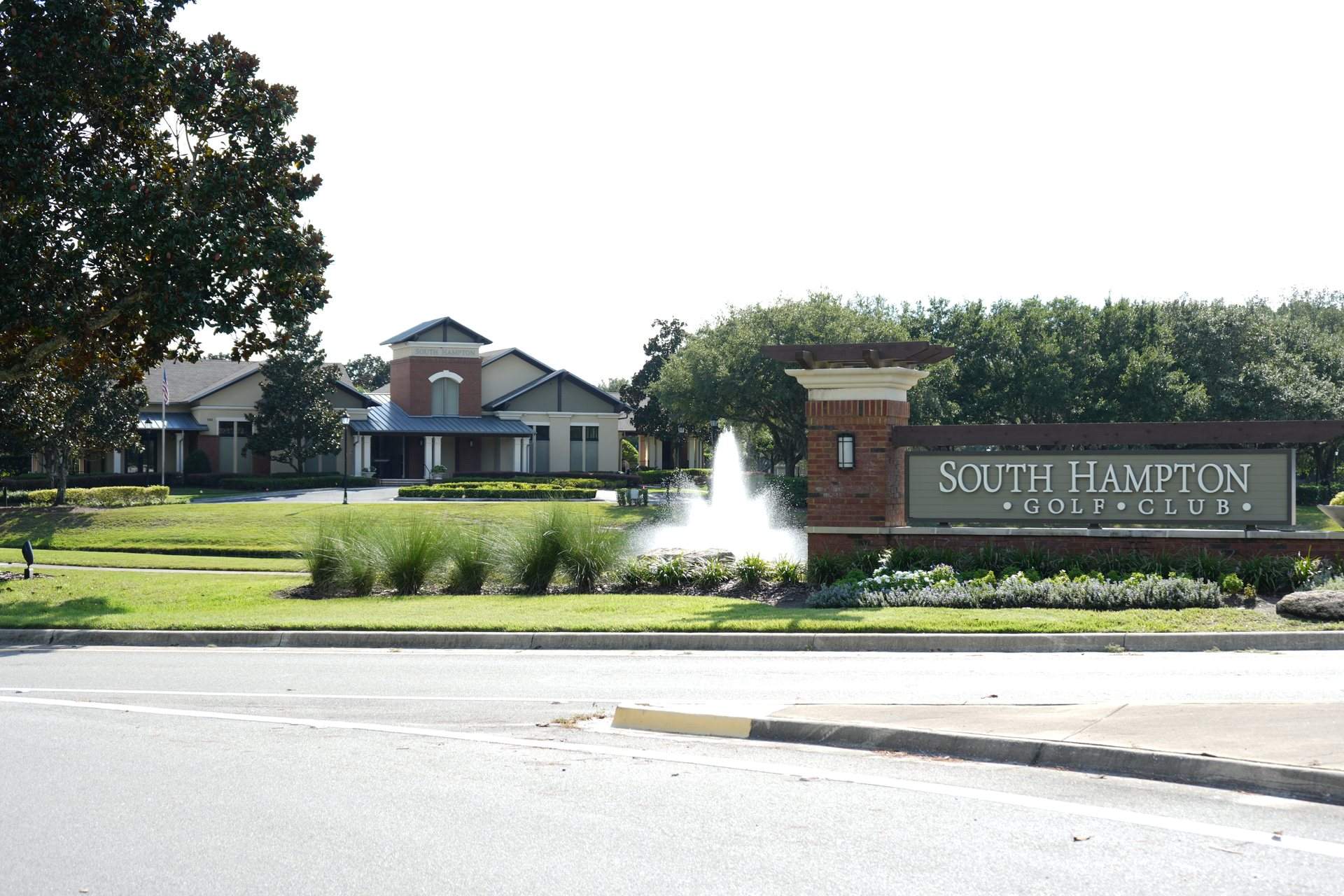 South Hampton Golf Club entrance sign with a fountain and the clubhouse behind it